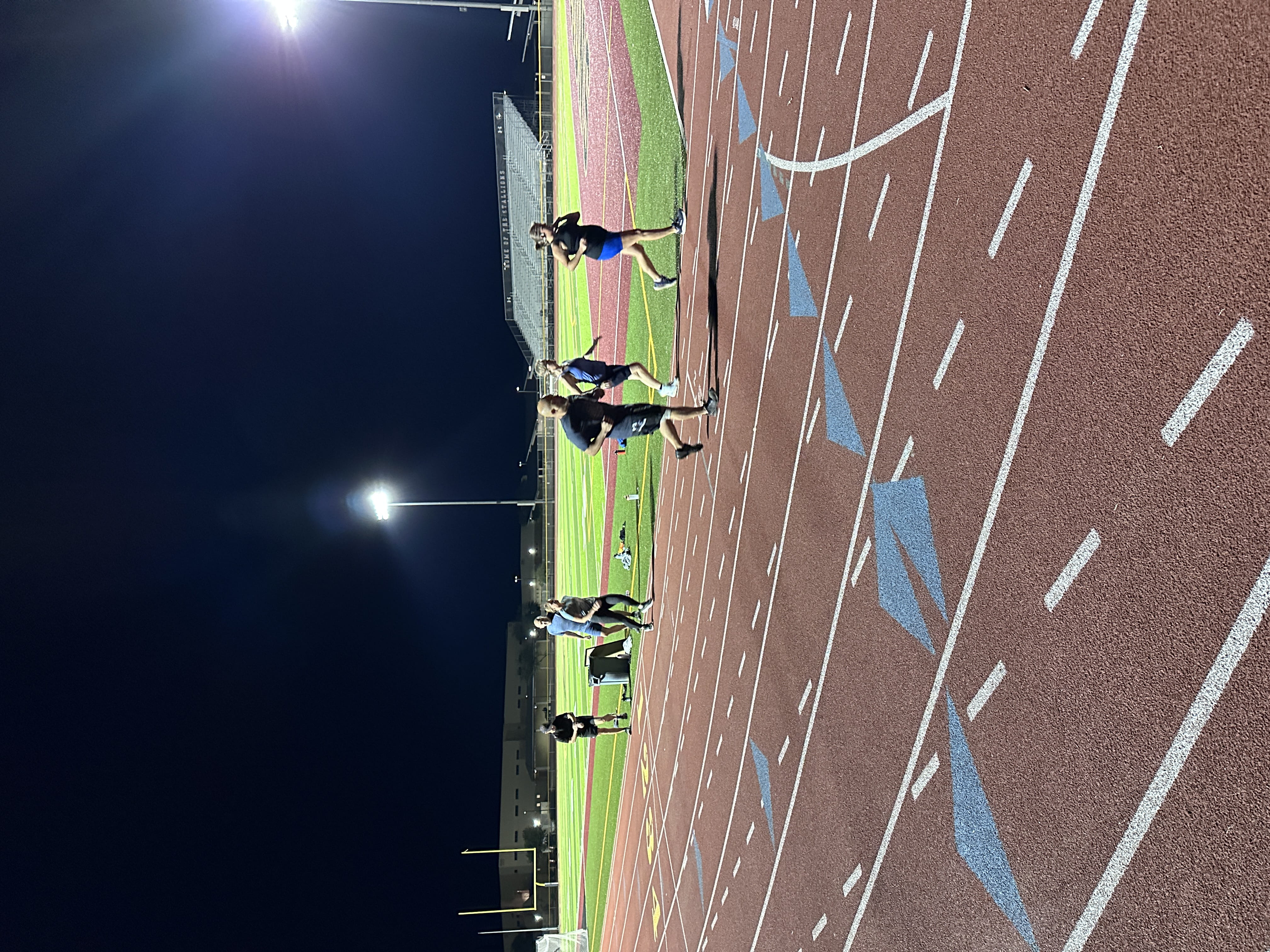 runners on red track running together