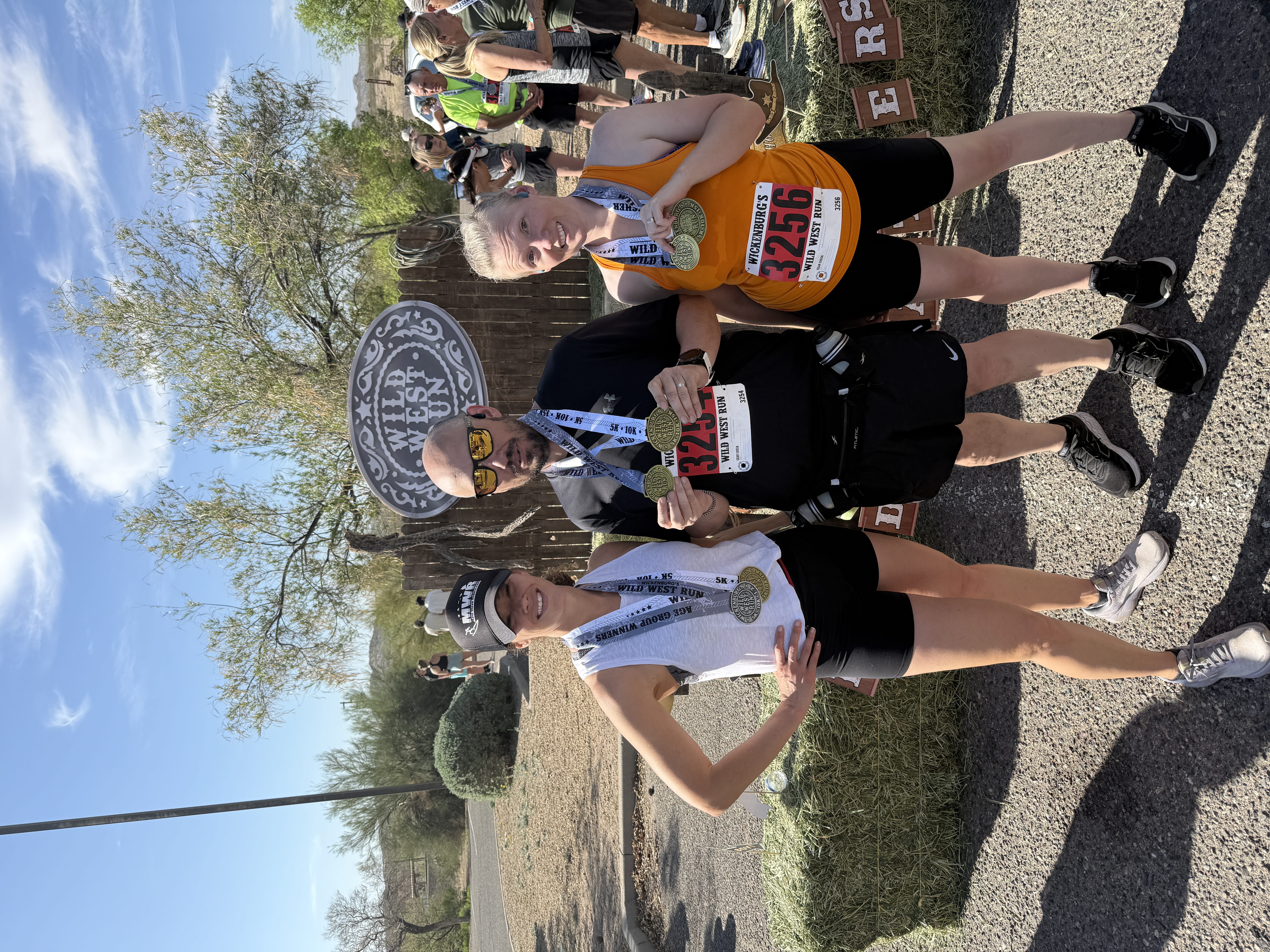 runners posing for photo with race medals