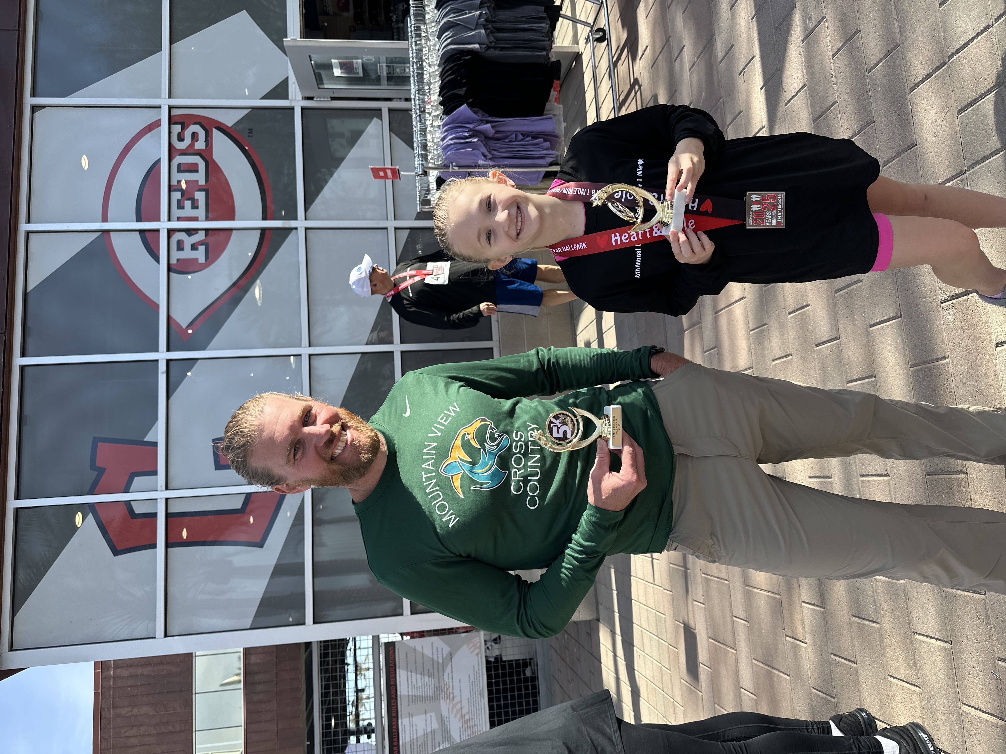 Coach Arrick holding a 5k medal